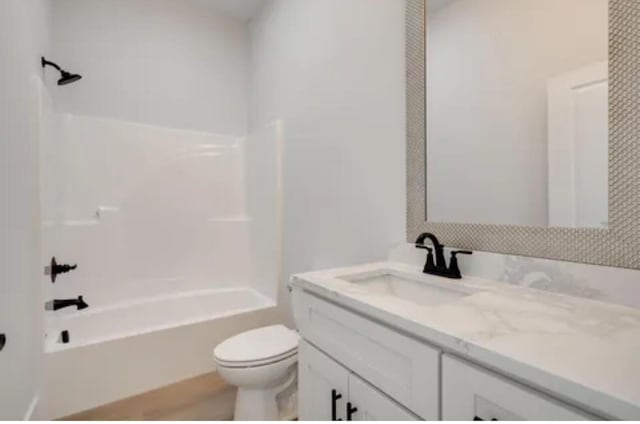 bathroom with shower / bath combination, vanity, and toilet