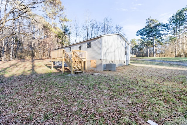 exterior space with stairway, cooling unit, and a deck