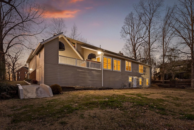 rear view of house featuring central AC unit