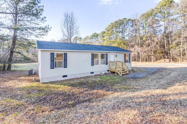 manufactured / mobile home featuring a shingled roof, crawl space, and central air condition unit