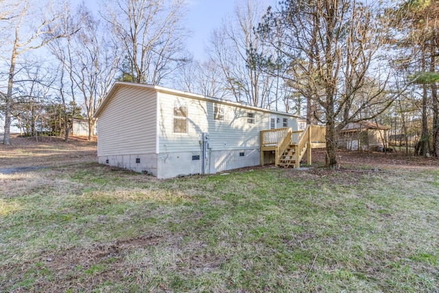 back of house featuring crawl space, a yard, stairs, and a wooden deck