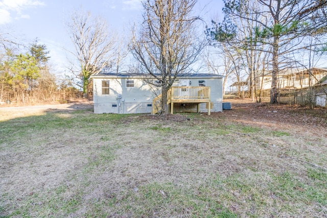 rear view of property featuring central AC unit, crawl space, and a wooden deck