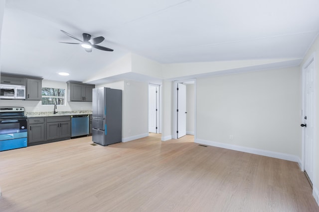 kitchen with electric stove, gray cabinets, white microwave, freestanding refrigerator, and dishwasher