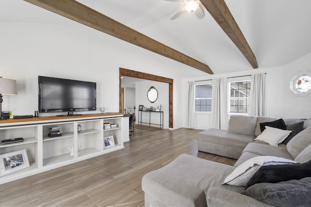living area with vaulted ceiling with beams, light wood-style floors, and ceiling fan