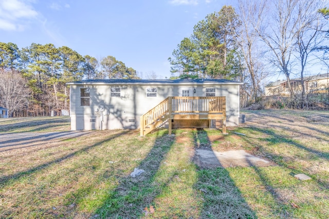 view of front of property featuring crawl space, a wooden deck, and a front yard