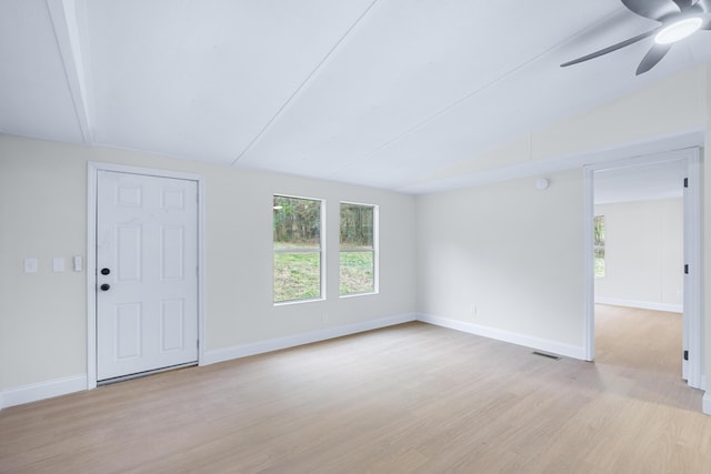 spare room with baseboards, plenty of natural light, and light wood-style floors