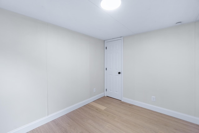 empty room with baseboards and light wood finished floors