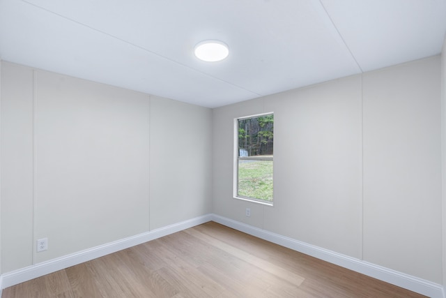 spare room with light wood-style flooring and baseboards