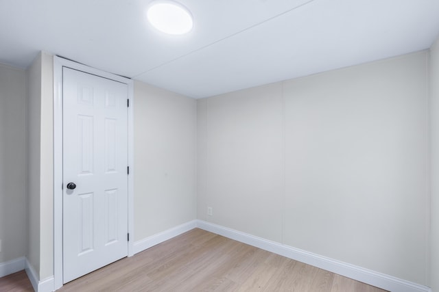 interior space featuring light wood-style flooring and baseboards