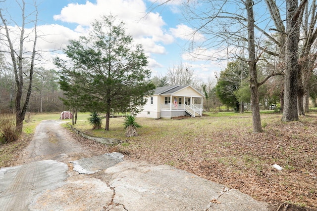 view of front of home featuring crawl space, covered porch, and dirt driveway