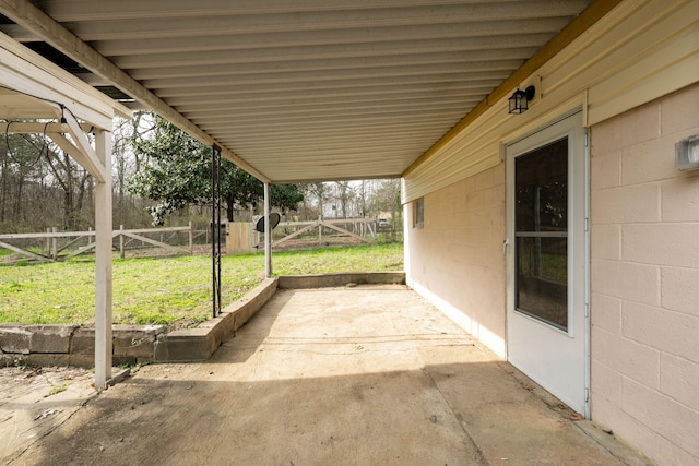 view of patio / terrace featuring a carport, fence, and a gate