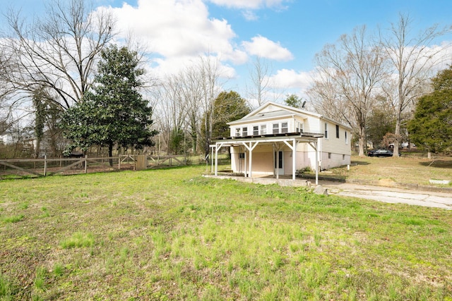 exterior space featuring a front yard, a patio area, fence, and a deck