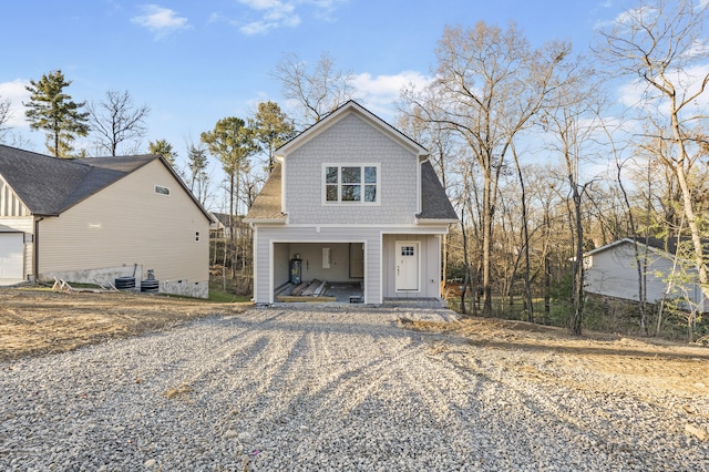 view of front of home with a shingled roof, board and batten siding, and a porch