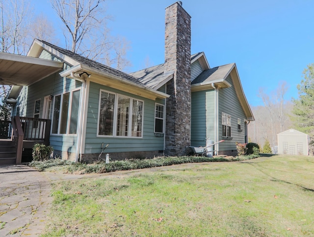 view of property exterior featuring a storage shed, an outdoor structure, a yard, crawl space, and a chimney