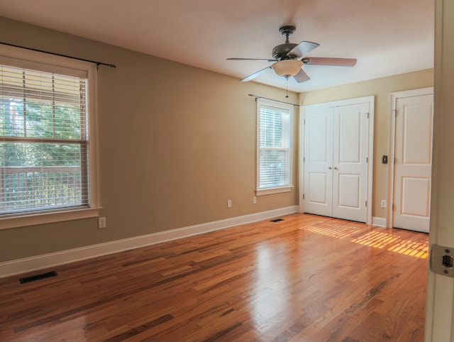 unfurnished bedroom with baseboards, visible vents, and light wood-style floors