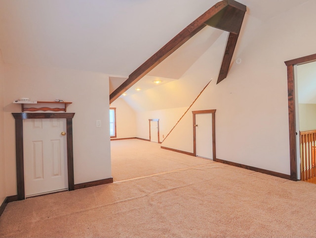 bonus room with carpet flooring, lofted ceiling with beams, and baseboards