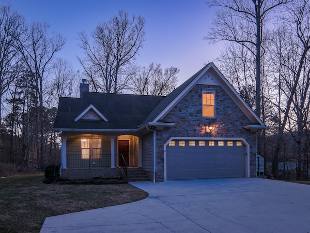 traditional-style house featuring concrete driveway, stone siding, a chimney, an attached garage, and a porch