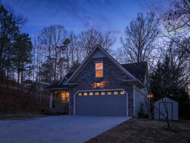 traditional-style house featuring an outbuilding, a porch, a shed, stone siding, and driveway