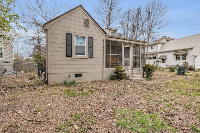 bungalow-style house with a sunroom, crawl space, and fence