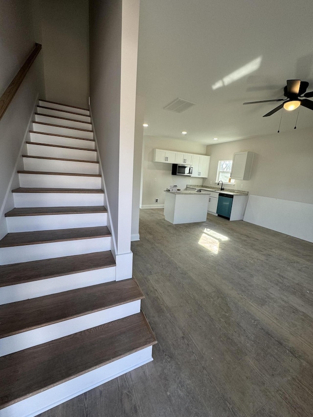 stairs with ceiling fan, wood finished floors, visible vents, and recessed lighting