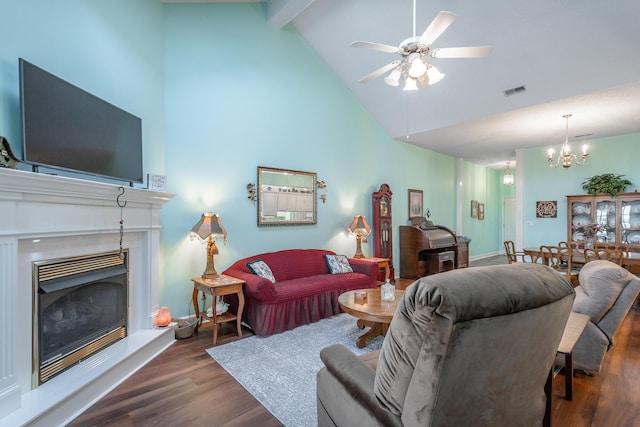 living room featuring a fireplace with raised hearth, visible vents, wood finished floors, high vaulted ceiling, and ceiling fan with notable chandelier