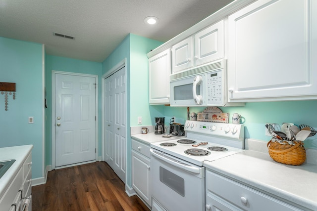 kitchen with white appliances, dark wood-type flooring, visible vents, white cabinetry, and light countertops