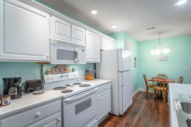 kitchen with a textured ceiling, white appliances, dark wood-type flooring, white cabinets, and light countertops