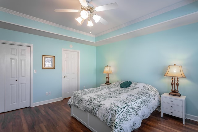 bedroom featuring a closet, wood finished floors, a ceiling fan, and baseboards