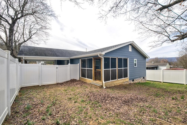 back of property with crawl space, a fenced backyard, and a sunroom