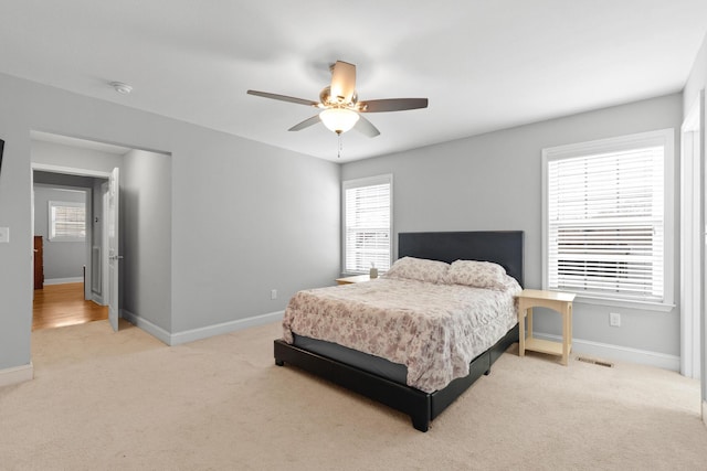 bedroom with a ceiling fan, carpet, and baseboards