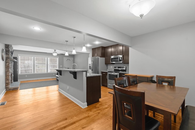 dining room with recessed lighting, visible vents, a ceiling fan, light wood-type flooring, and baseboards