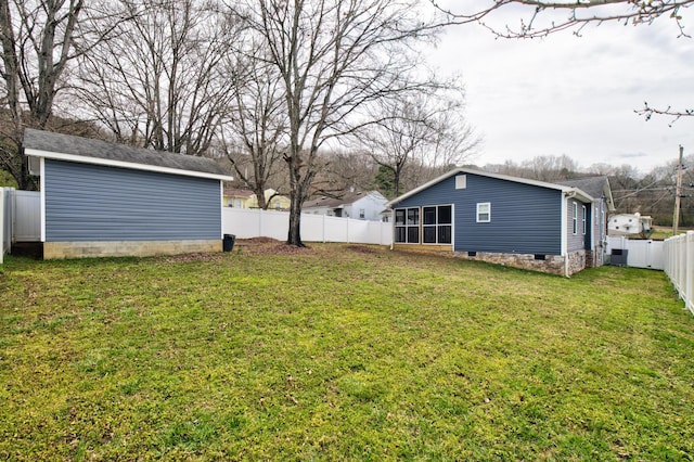 view of yard with an outbuilding and a fenced backyard