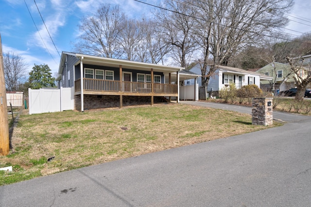 ranch-style home with aphalt driveway, a front yard, and fence