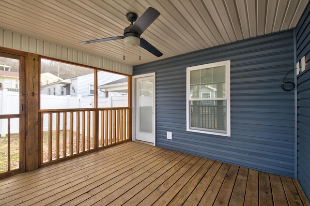 unfurnished sunroom featuring ceiling fan