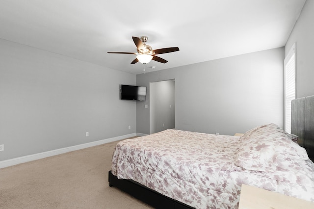 carpeted bedroom with a ceiling fan and baseboards