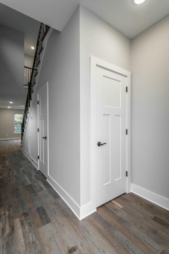 hall featuring stairs, wood finished floors, and baseboards