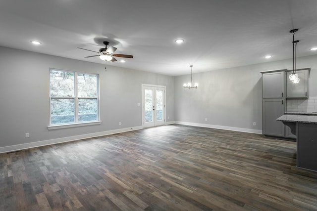 unfurnished living room with recessed lighting, dark wood-style flooring, a healthy amount of sunlight, and baseboards