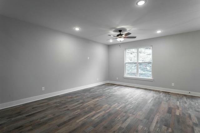 spare room featuring a ceiling fan, baseboards, dark wood-type flooring, and recessed lighting