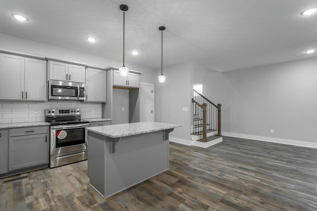 kitchen with appliances with stainless steel finishes, recessed lighting, dark wood finished floors, and tasteful backsplash