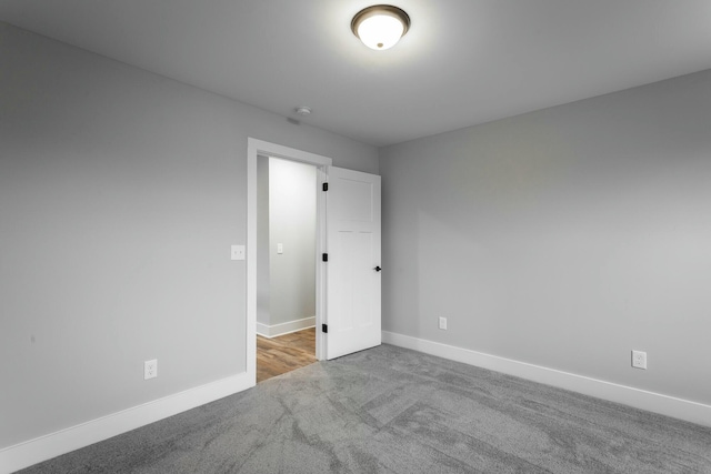 spare room with carpet floors and baseboards