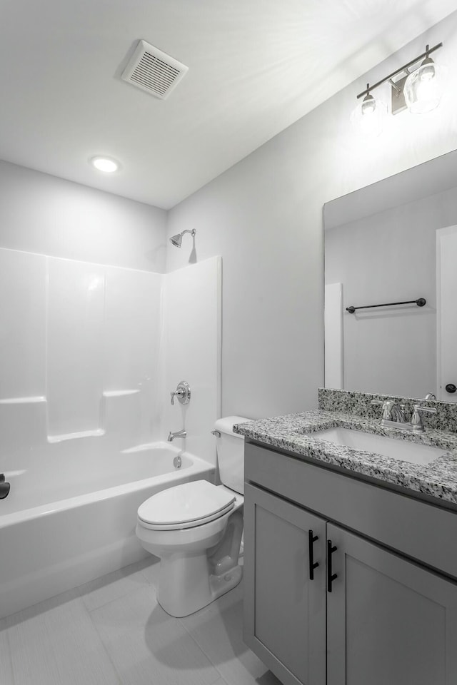 full bathroom with bathtub / shower combination, toilet, vanity, visible vents, and tile patterned floors