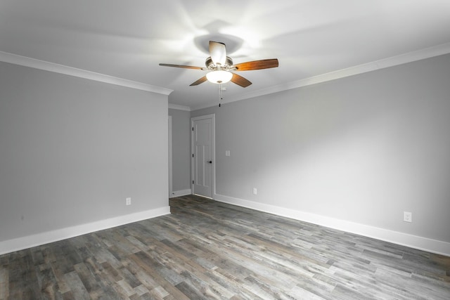 spare room featuring dark wood-type flooring, crown molding, baseboards, and ceiling fan