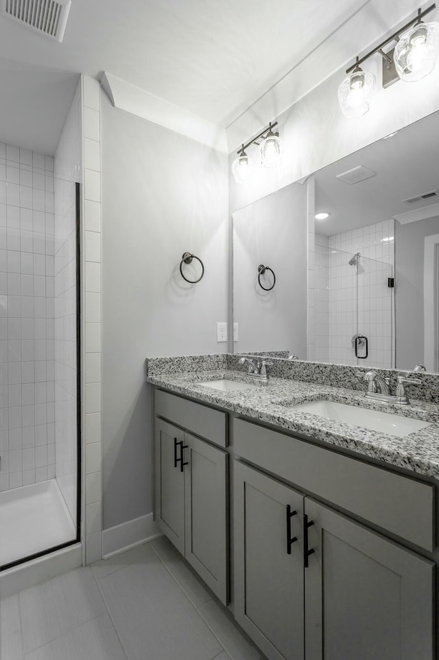 full bath featuring a sink, visible vents, and a shower stall