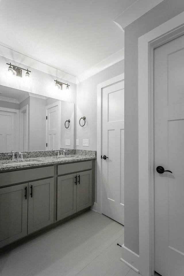 bathroom with a sink and double vanity