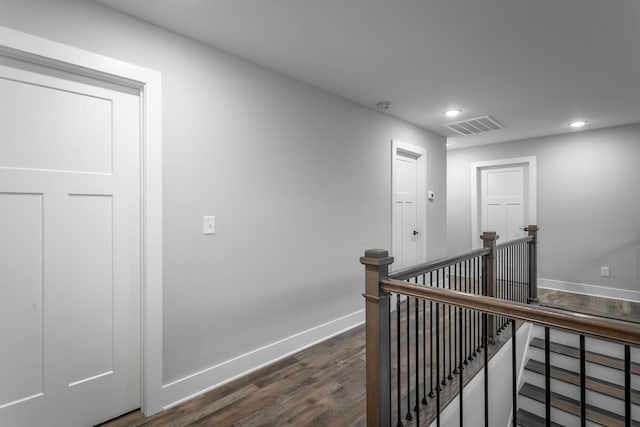 hall featuring recessed lighting, visible vents, dark wood-type flooring, an upstairs landing, and baseboards