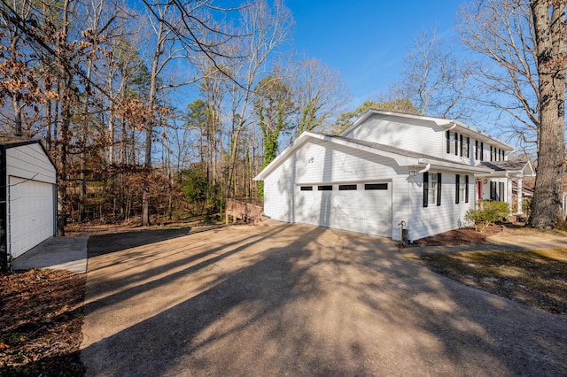 view of side of property featuring a garage and driveway