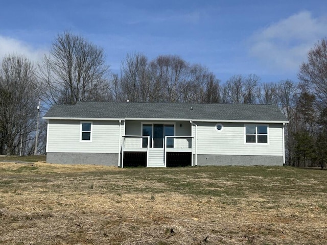 single story home with a shingled roof and a front lawn