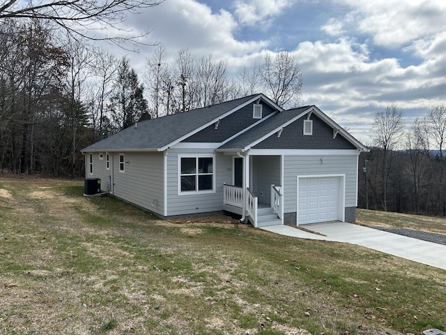 view of front of home with a front yard, driveway, and an attached garage