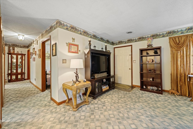 carpeted living area with visible vents, baseboards, and a textured ceiling