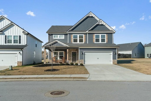 craftsman-style house featuring a porch, a garage, concrete driveway, stone siding, and board and batten siding